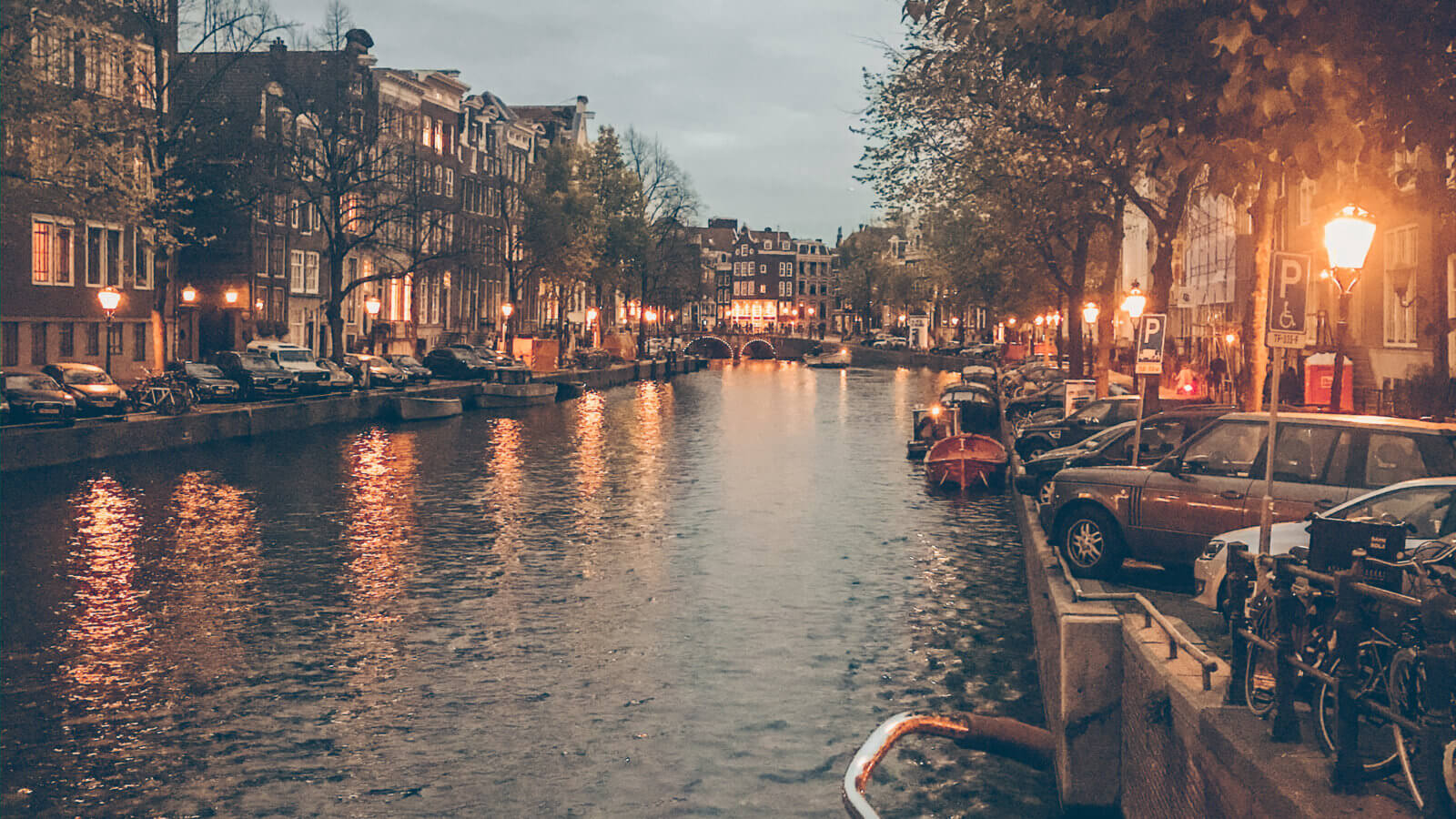 Canals of Amsterdam and narrow canal houses with a bike