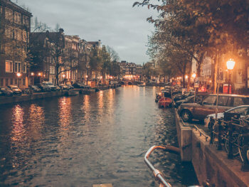 Canals of Amsterdam and narrow canal houses with a bike